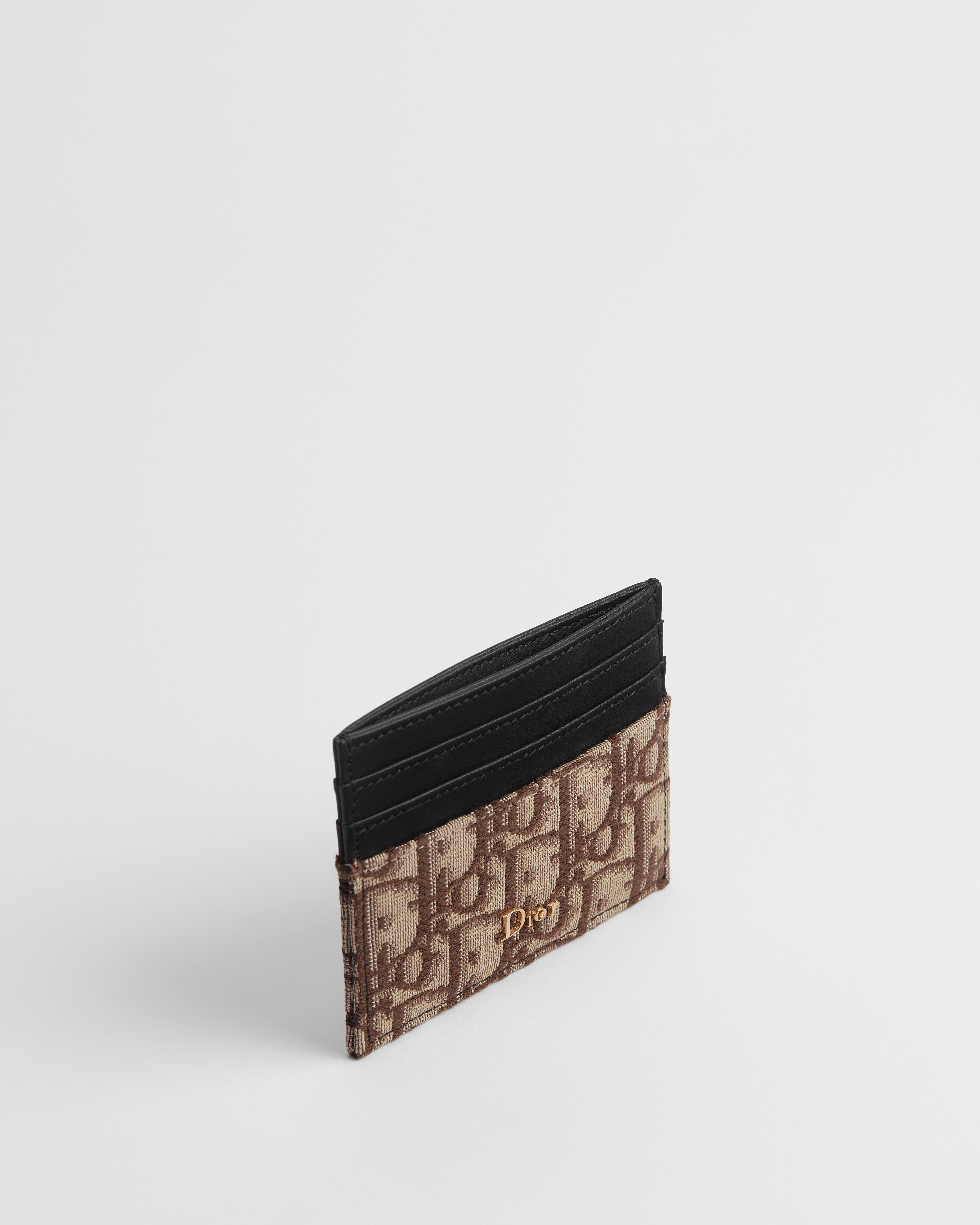 حاملة بطاقات جلد العجل الناعم المطعّم الأسود ونمط ديور أوبليك البني بحبك الجاكار E06