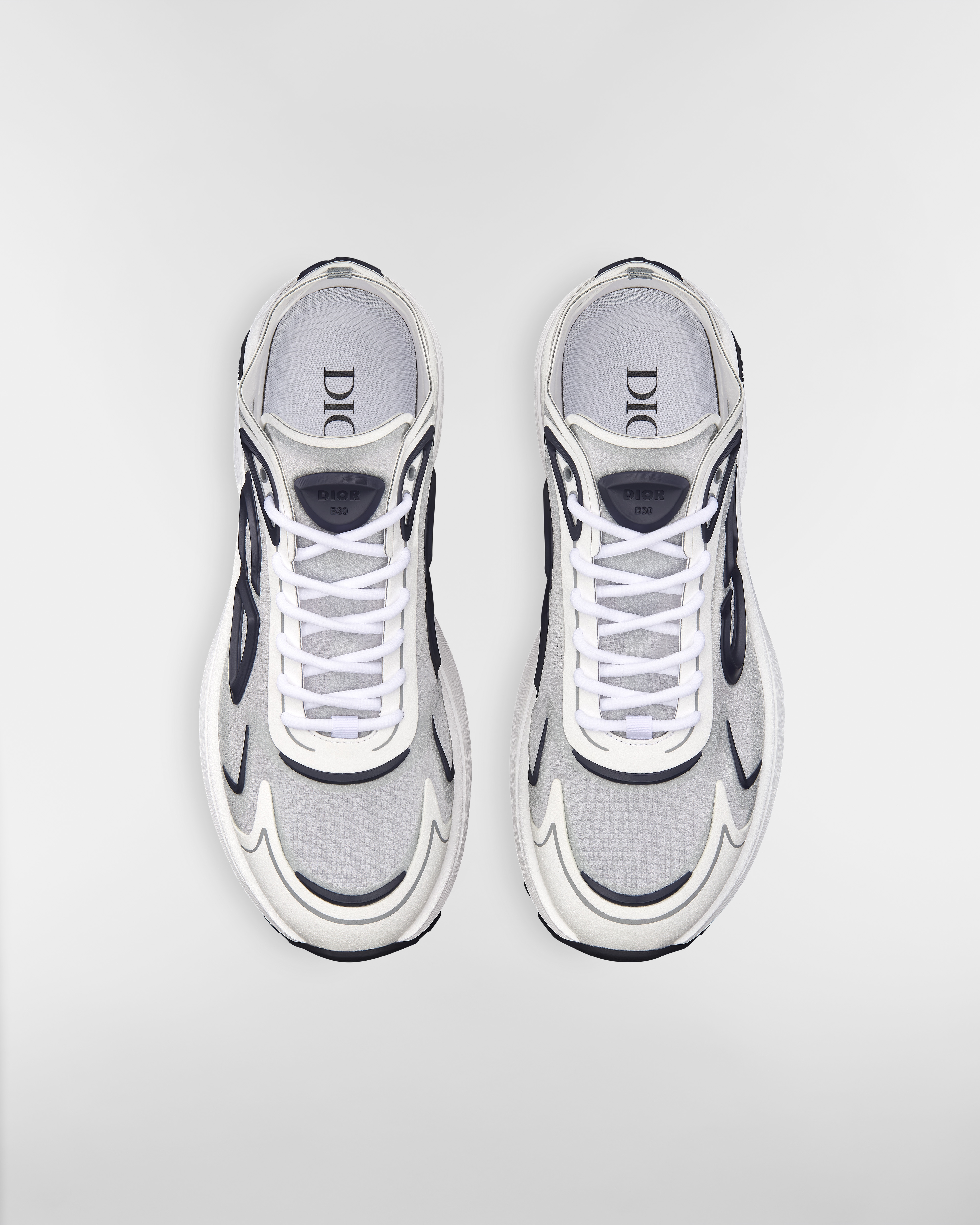 รองเท้าสนีกเกอร์ B30 Countdown Tech ผ้าไนลอน N3O กึ่งโปร่งสีขาว ผ้าเทคนิคัลสีขาวและสีเทา และยางสีน้ำเงินเนวี่ E06