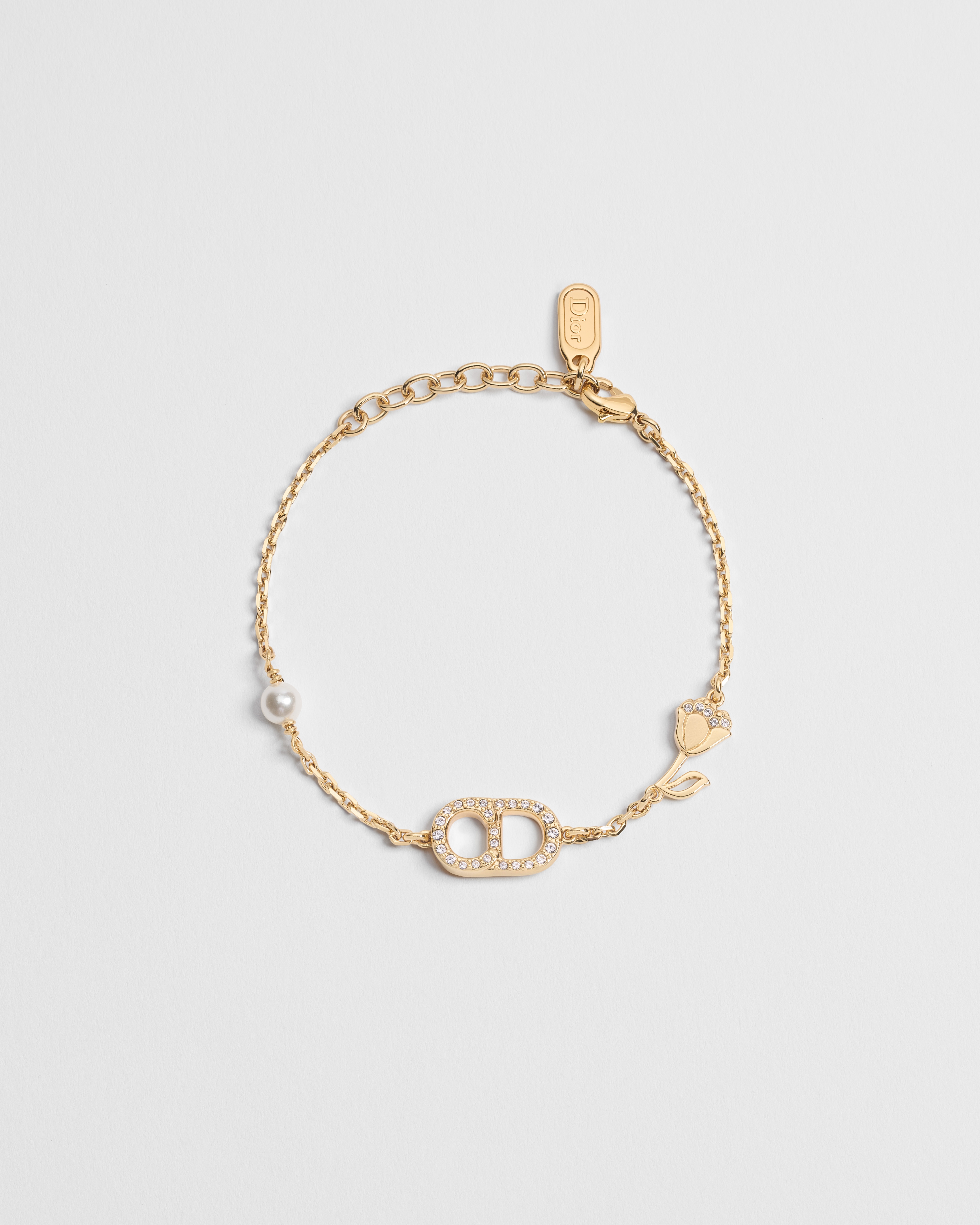 Bracelet CD Lily Métal finition dorée, perles en résine blanche et cristaux E01