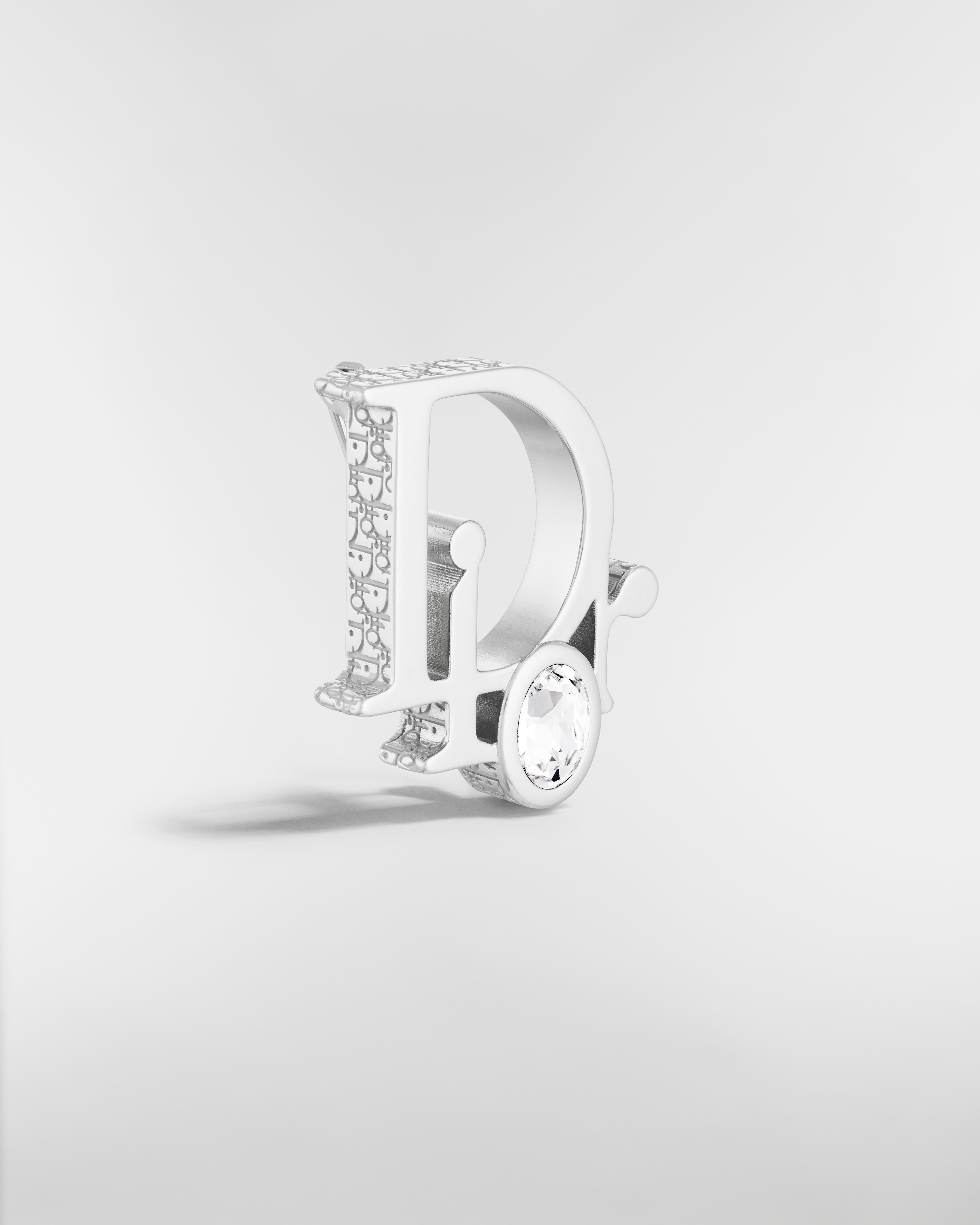 Broche Dior Sparkle Laiton argenté, cristal blanc et résine grise E03
