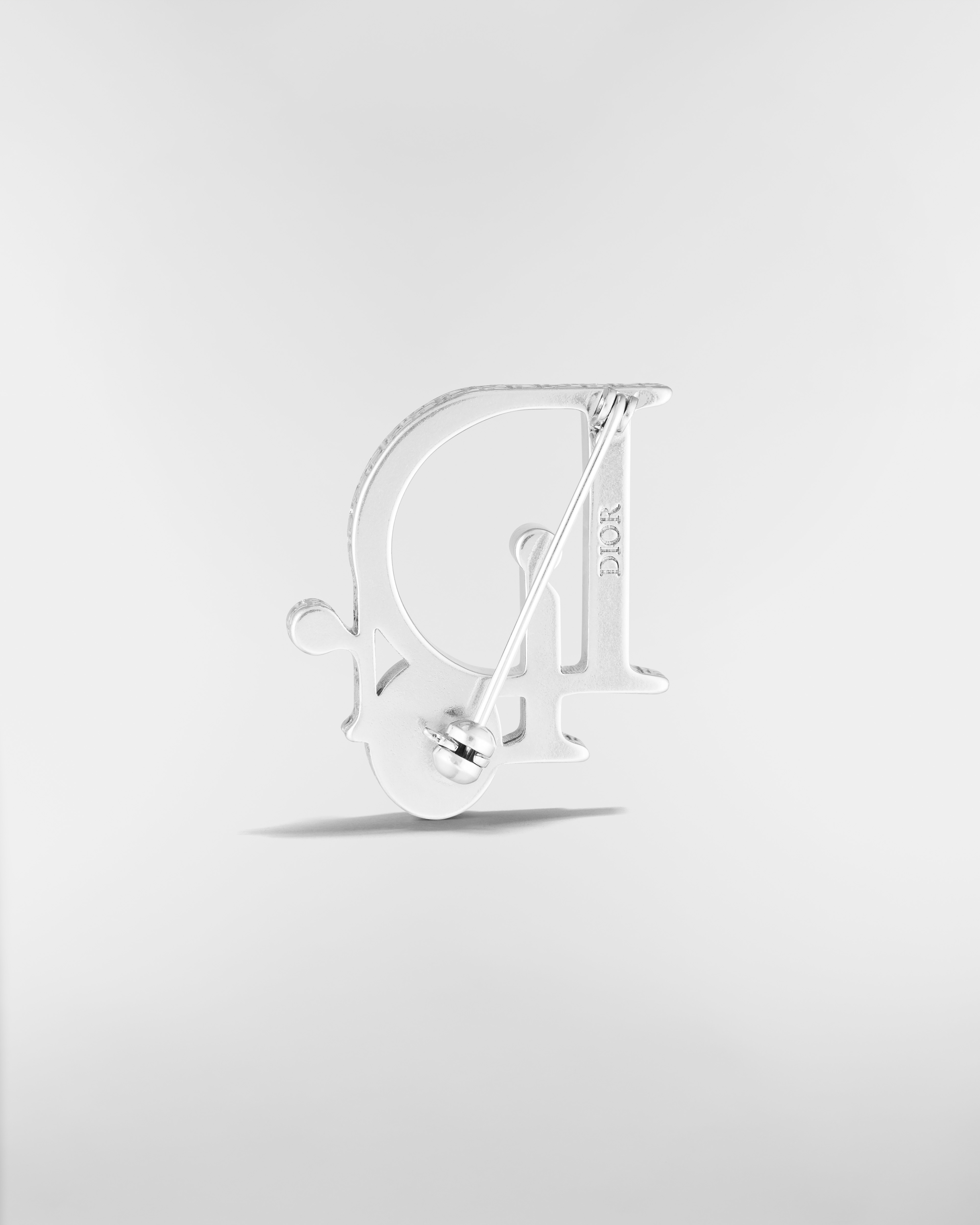 Broche Dior Sparkle Laiton argenté, cristal blanc et résine grise E08